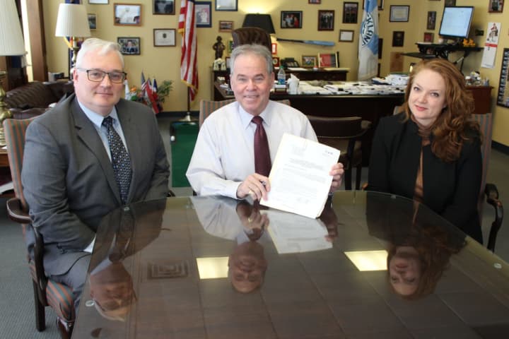 Rockland County Executive Ed Day, center, after signing the measure.