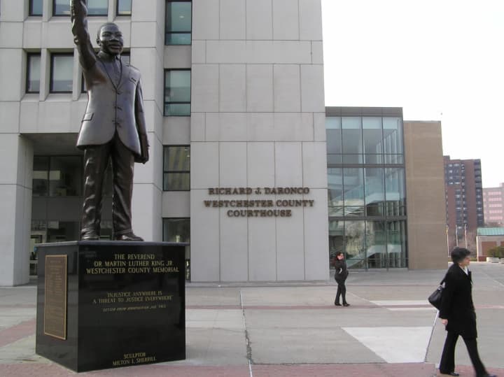 A person threw a suspicious white powder around two statues in front of the Westchester County Courthouse on Wednesday.
