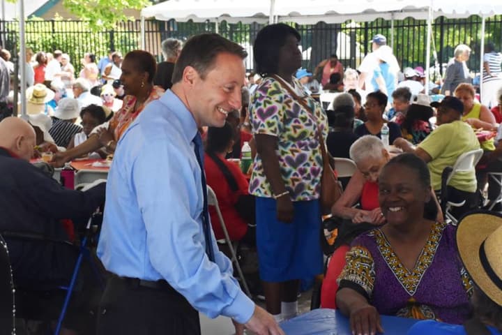 Rob Astorino talks with some of the guests at the Westchester annual senior pool party/barbeque in White Plains.