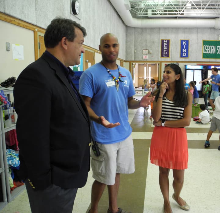 State Sen. George Latimer, left, talks with John Rice, Rye Y Camp, family and teen director, and board member Uma Khemlani during his recent visit to the camp. 