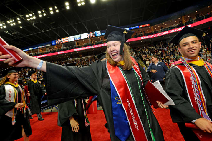 Theresa “T” Fletcher, Sacred Heart University class of 2017 president, celebrates after the undergraduate commencement at Webster Bank Arena in Bridgeport on Sunday.