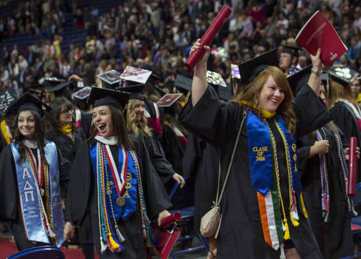 Graduates cheer at Sacred Heart University&#x27;s undergraduate commencement exercises on May 15 at the Webster Bank Arena in Bridgeport.