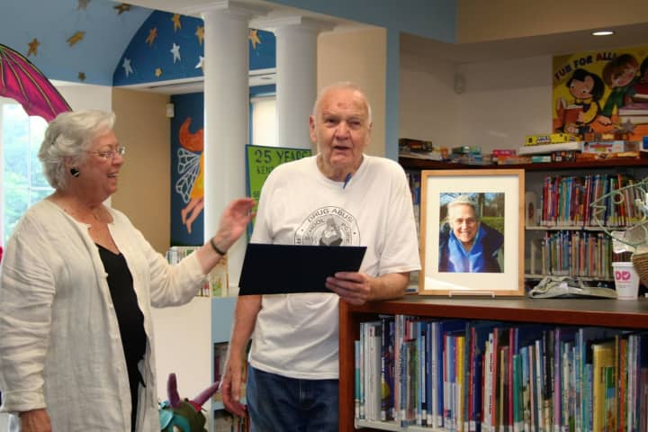 Sandy Galef presents a proclamation to Jim Baker as the children&#x27;s room was dedicated to Wilma Baker.