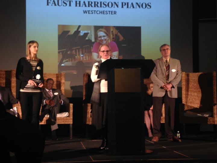 Sarah Faust, president of Faust Harrison Pianos (center), accepts award honoring her firm as one of the most outstanding family-owned businesses in Westchester.