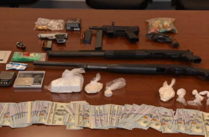 Weapons, cash and drugs gathered in the investigation that saw 30 people arrested for selling heroin and cocaine.