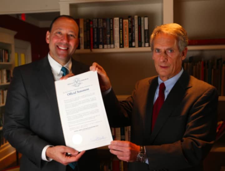 Attorneys Steven Frederick (left) and Marshall Goldberg, pose with the official declaration of Nov. 9 as “Wofsey, Rosen, Kweskin &amp; Kuriansky Day in the State of Connecticut.”