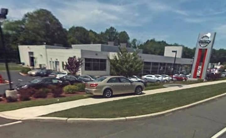 A car salesman at Rockland Nissan was arrested for allegedly stealing the identities of customers and opening credit card accounts.