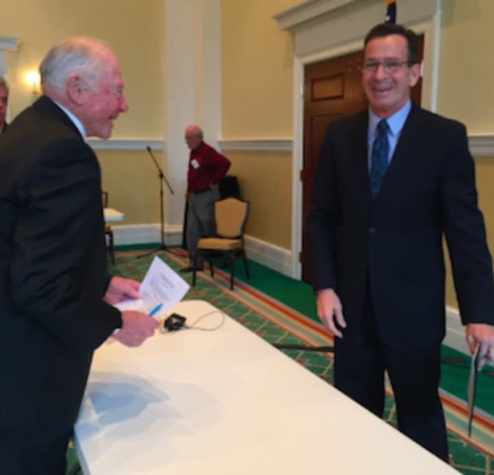 Gov. Dannel Malloy shares a laugh with Bob Wylie from the Retired Men&#x27;s Association of Greenwich after speaking to the group Wednesday.
