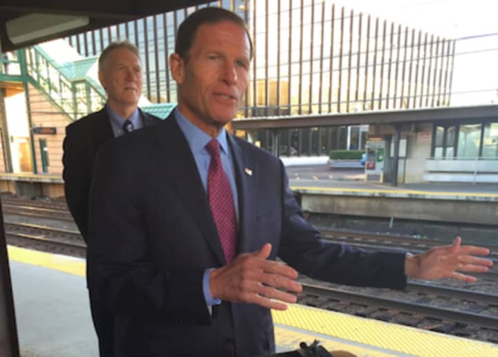 U.S. Sen. Richard Blumenthal makes a point about the restoration of the commuter tax benefit at the Greenwich Train Station while John Hartwell looks on.