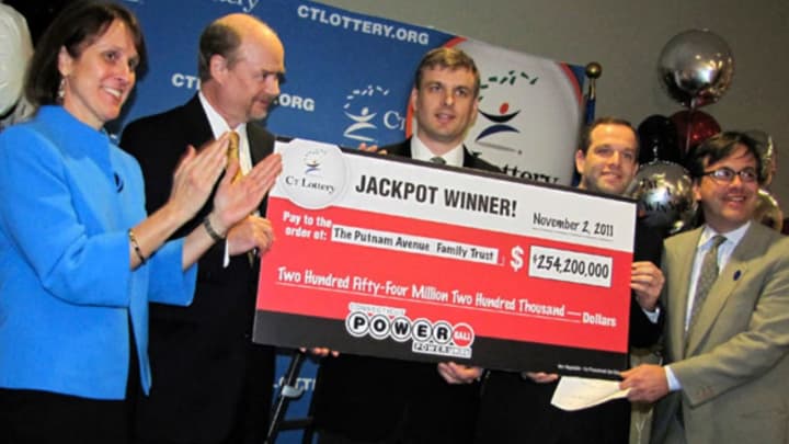 Putnam Avenue Family Trust claims the largest prize of $254.2 million in CT Lottery history in 2011. Anne M. Noble, CT Lottery president; Timothy Davidson, Gregory Skidmore and Brandon Lacoff of the trust; and Frank Farricker, CT Lottery, Chairman.