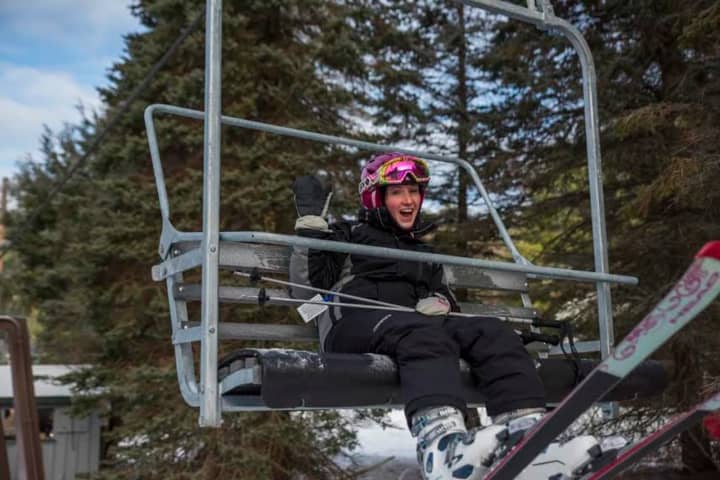 A happy skier enjoys the ride on the chairlift Friday at Ski Sundown.