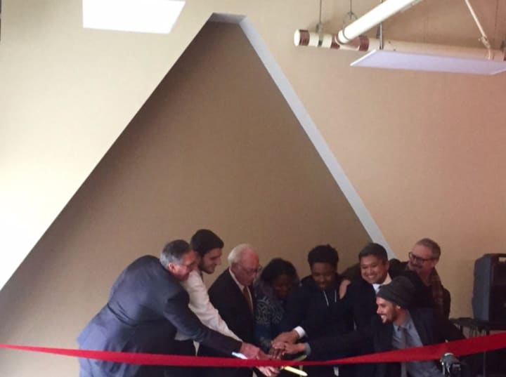 Purchase College President Thomas Schwarz (center) at a ribbon-cutting ceremony with students and faculty, dedicating a new multicultural center at Fort Awesome dormitory.