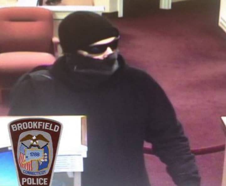 A man described as a 5-foot-10 white male dressed all in black clothing robbed a bank in Brookfield on Monday afternoon.