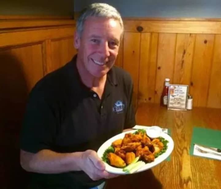 Wings -- to go or eat in -- are on tap at Kelly&#x27;s Corner in Brewster where Owner Kelly Quinn poses with an order.