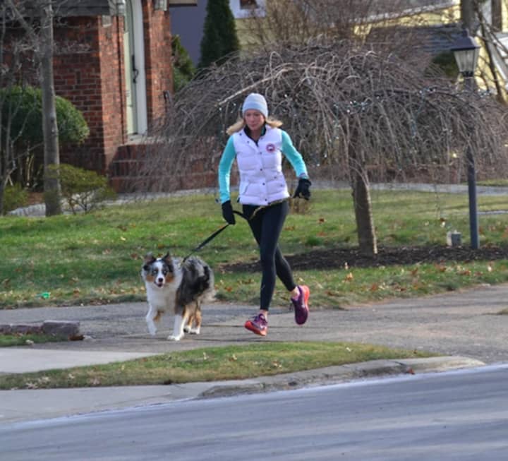 Anne McDonnell takes a dog for a run in Ridgewood.