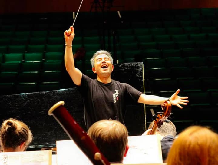 Conductor Jun Nakabayashi rehearses the Festival Orchestra for Hoff-Barthelson Music School.