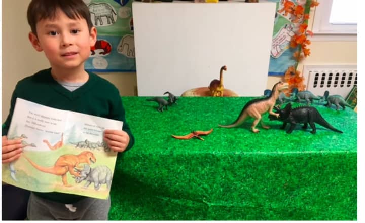 Tommy Mullen has fun with dinosaurs at the Weinberg Nature Center in Scarsdale.