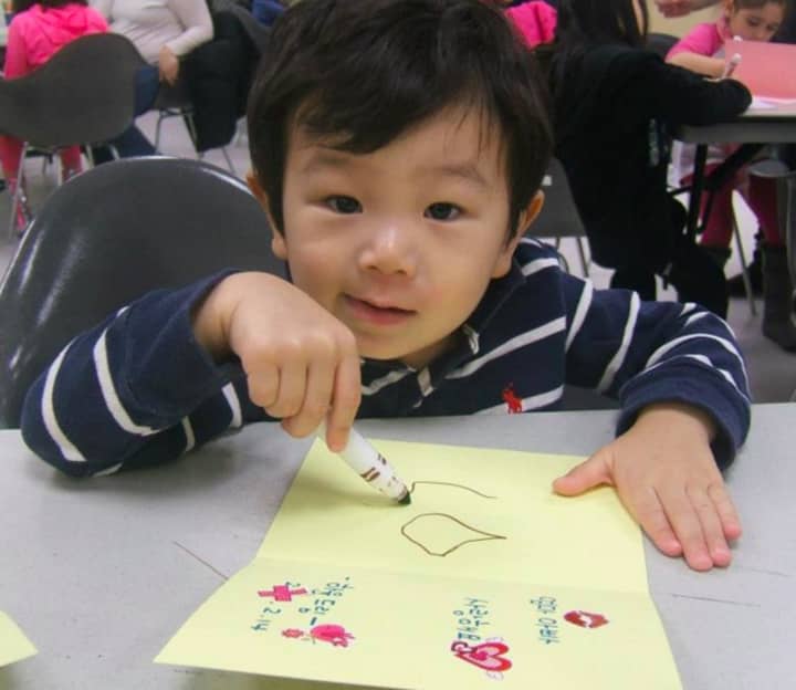 A youngster makes a Valentine&#x27;s Day card at the Leonia Library.