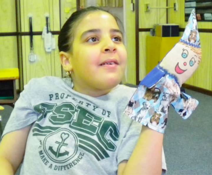 A student at The Felician School in Lodi gets to know her &quot;From Heart To Hands&quot; puppet.