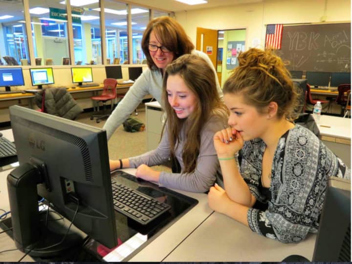 Briarcliff High School yearbook advisor Nina Marcel (left) worked with two of The Bruin editors on designing the award-winning 2015 edition.