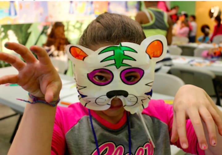 Members of the Boys and Girls Club enjoy their time at the event making tiger masks.