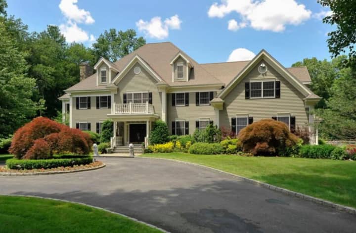 A majestic six-bedroom Colonial at 1 Stillwater Place in Bedford offers country club living and privacy.