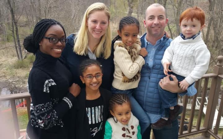 Amy Stellwagen, back, second from left, and her husband, Jon, of Mamaroneck, with their son, Chase (right) will oversee the care of Gabby, Reagan and Riley along with Tethra Wallace (back row, left).
