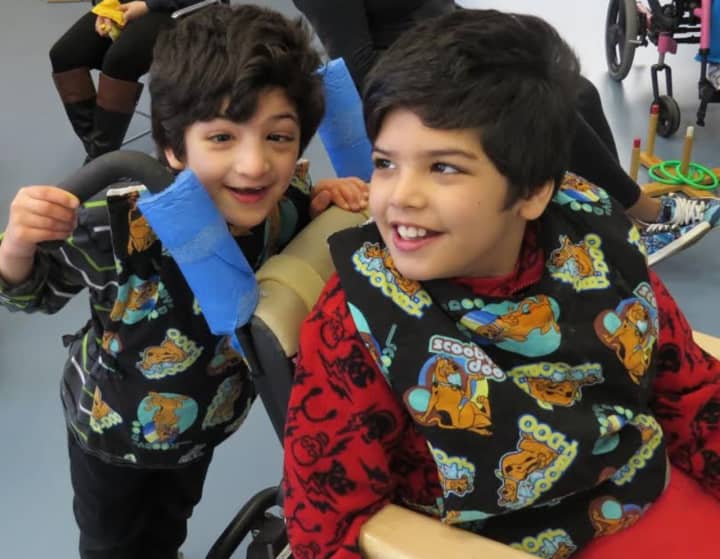 Brothers Yosuf (standing) and Sultan (seated) receive occupational, physical and speech therapies at the school program at Cerebral Palsy of Westchester.