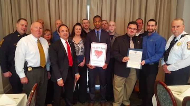 Mayor Joe Ganim, front row, second from left, accepts a state plaque declaring Bridgeport a HEARTSafe community.