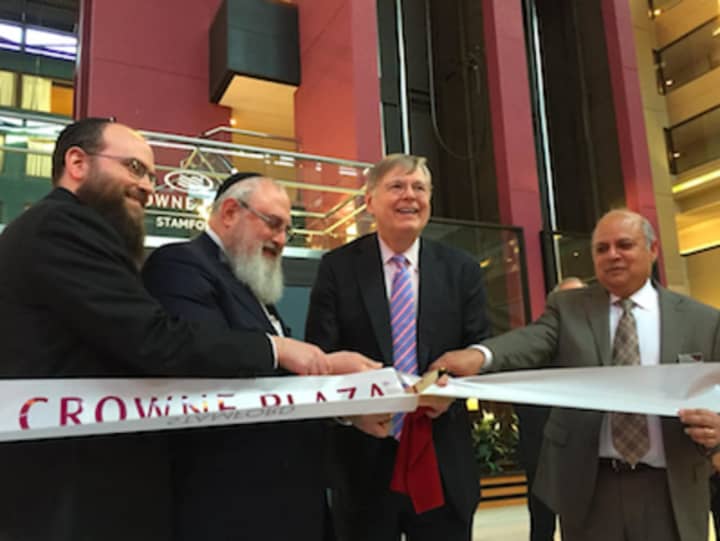 The Crowne Plaza Hotel at 2701 Summer St., Stamford, celebrated its grand re-opening Wednesday. From left: Rosdev Group&#x27;s Thomas Rosenberg and Michael Rosenberg, Mayor David Martin and hotel general manager Sanj Rai.