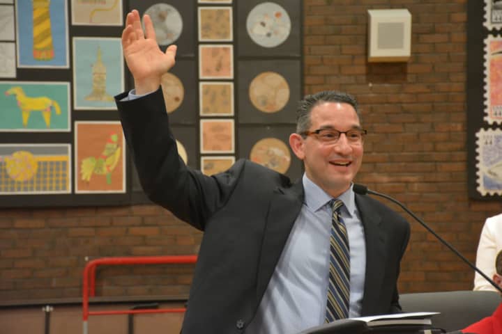Dr. Christopher Manno, who has been named Bedford Central&#x27;s new schools superintendent, address the crowd. He is pictured raising his hand while asking a question from the audience.