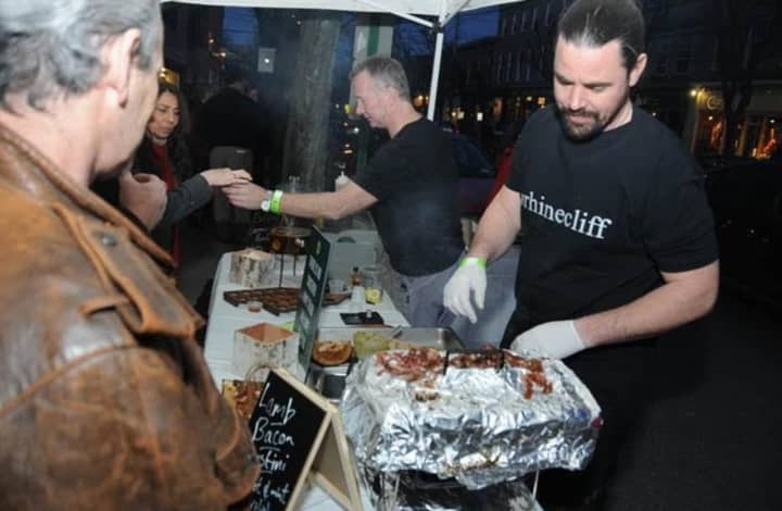 James Chapman, center, and Dale Andrews, right, from The Rhinecliff Hotel serve lamb and bacon crostini during this year&#x27;s Taste of Rhinebeck.