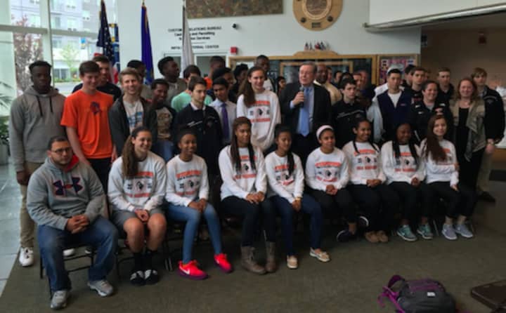 Mayor David Martin, center, introducing the Stamford High School girls&#x27; basketball, Westhill boys&#x27; basketball team and the Stamford-Westhill boys&#x27; hockey team at the Government Center Tuesday. All the teams won state championships this year.