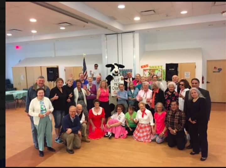 The Danbury Senior Center recently held a sock hop. Danbury Mayor Mark Boughton (kneeling, far left) attended the event. Staff members from Chick Fil A in Brookfield also attended.