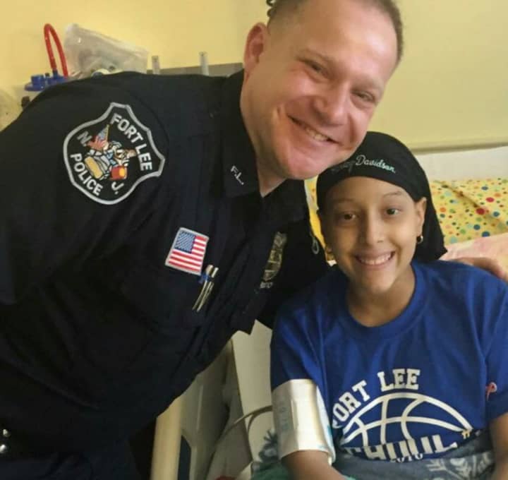 Fort Lee Detective Nick Mircovich with Briana Lopez, 11, who has leukemia.