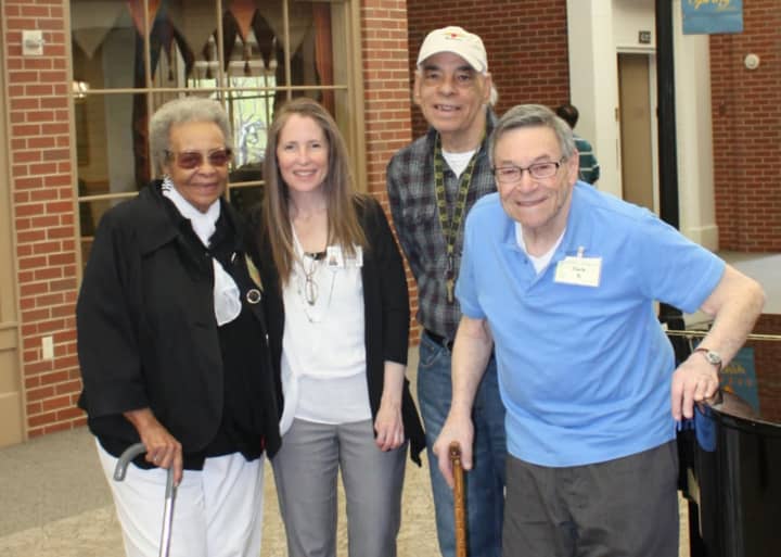 Anne Pelisson, second from left, is Supervisor of the Adult Day Program for the Waveny LifeCare Network in Network. Cora (left), Angel (second from right) and Jack are frequent visitors to the program.
