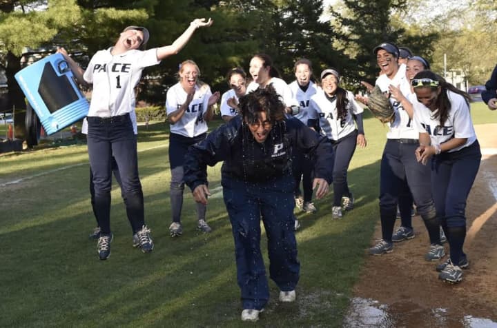 The Pace softball team gives head coach Claudia Stabile a victory shower after clinching the NE-10 Conference Championship.