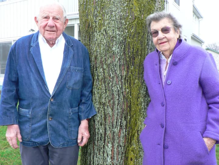 John and Lucy Jinishian in the front yard of their Marvin Beach cottage. They have been named Norwalk’s Tree Advocates of the Year.