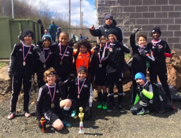 Members of the Stamford Youth Soccer League’s Stamford FC U11 Boys&#x27; Premier Team who played in the South Central Premier Spring Kick-Off Classic, pictured with their coach, Quality Touch Soccer Academy’s Jason Segovia.