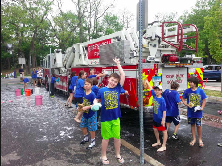 Fifth-graders from North Mianus School in Greenwich had a lot of fun and got very wet cleaning Greenwich fire trucks.