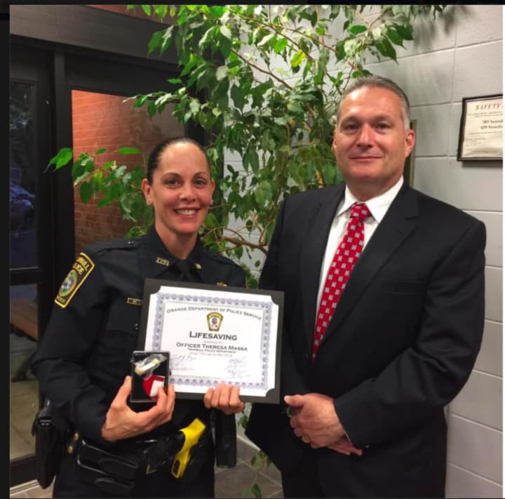 The Orange Police Department honored Trumbull Police Officer Theresa Massa with a Life Saving award for her efforts in saving a choking victim while off duty at Outback Steakhouse.