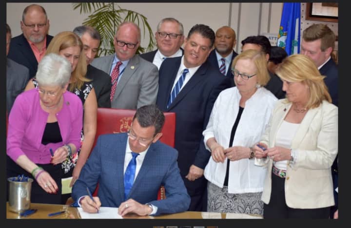 Gov. Dannel Malloy signs a bill Friday to combat the growing problem of opioid addiction in Connecticut.
