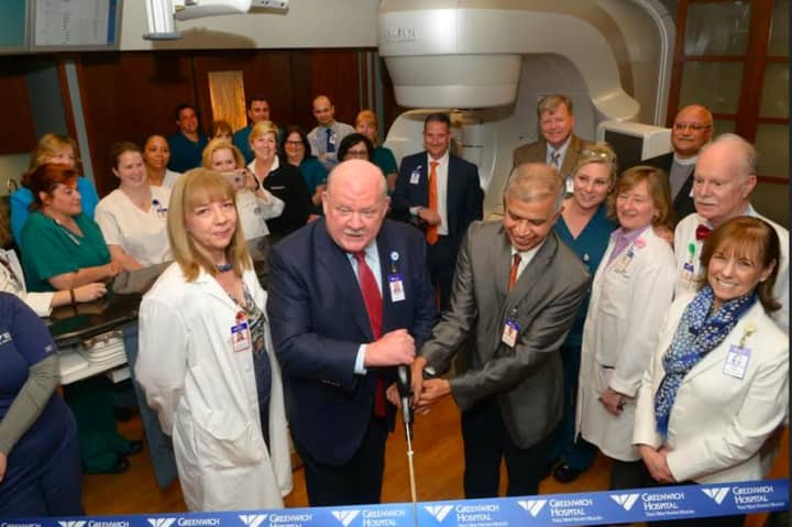 Greenwich Hospital President Norman G. Roth (left) and radiation oncologist Ashwatha Narayana cut the ribbon during a ceremony to unveil the new TrueBeam radiation therapy system.