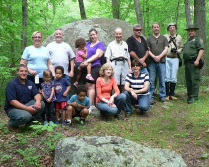 National Trails Day: David Solek, right, Monroe’s park ranger and tree warden, lines up with National Trails Day hikers in front of Whale Rock on Monroe’s Chalk Hill Nature Trail.