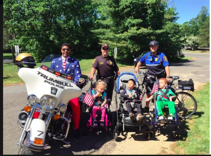 Trumbull police motor officer Scott Thompson and bicycle officer Michael Edwards celebrated Flag Day at the St. Vincent&#x27;s Special Needs Center with a group of kids.