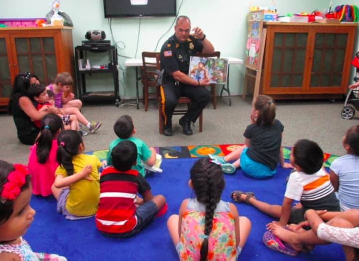 East Rutherford Police Captain Phillip Taormina read &quot;Officer Buckle and Gloria&quot; to a group of youngsters this Monday.