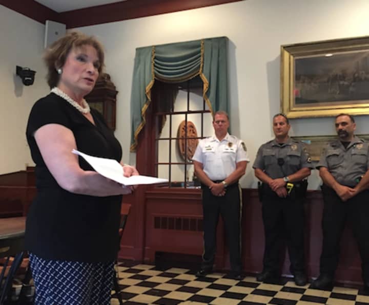 Weston First Selectman Nina Daniel leads a prayer service Friday for the police officers in Dallas killed and wounded Thursday night.