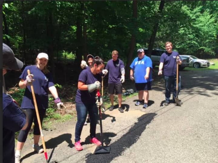 About 30 staff members from PKF O&#x27;Connor Davies accounting and advisory firm from Stamford and Wethersfield participate in a day of community service recently at Camp Candlewood in New Fairfield.