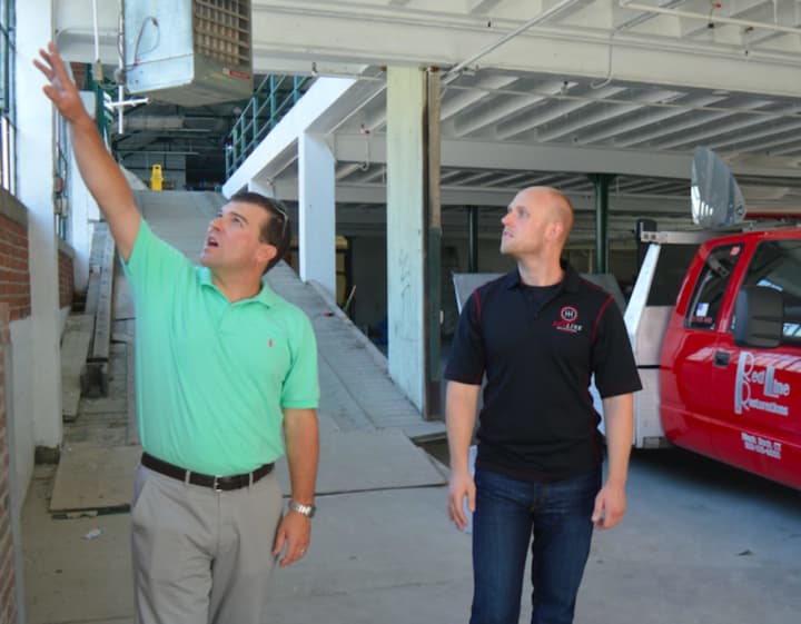 State Rep. Steve Stafstrom, left, and P.J. Pitcher of Redline Restorations tour the comany&#x27;s new facility in Bridgeport.