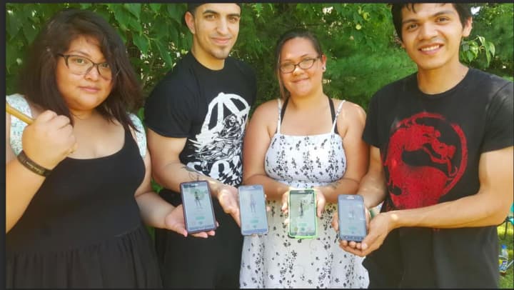 People searching for Pokemon at the Pokemon Go Crawl event on Sunday afternoon at Rogers Park in Danbury. From left, Melissa Humire, Nick Musto, Caitlin Bouaravong, Angel Benitez